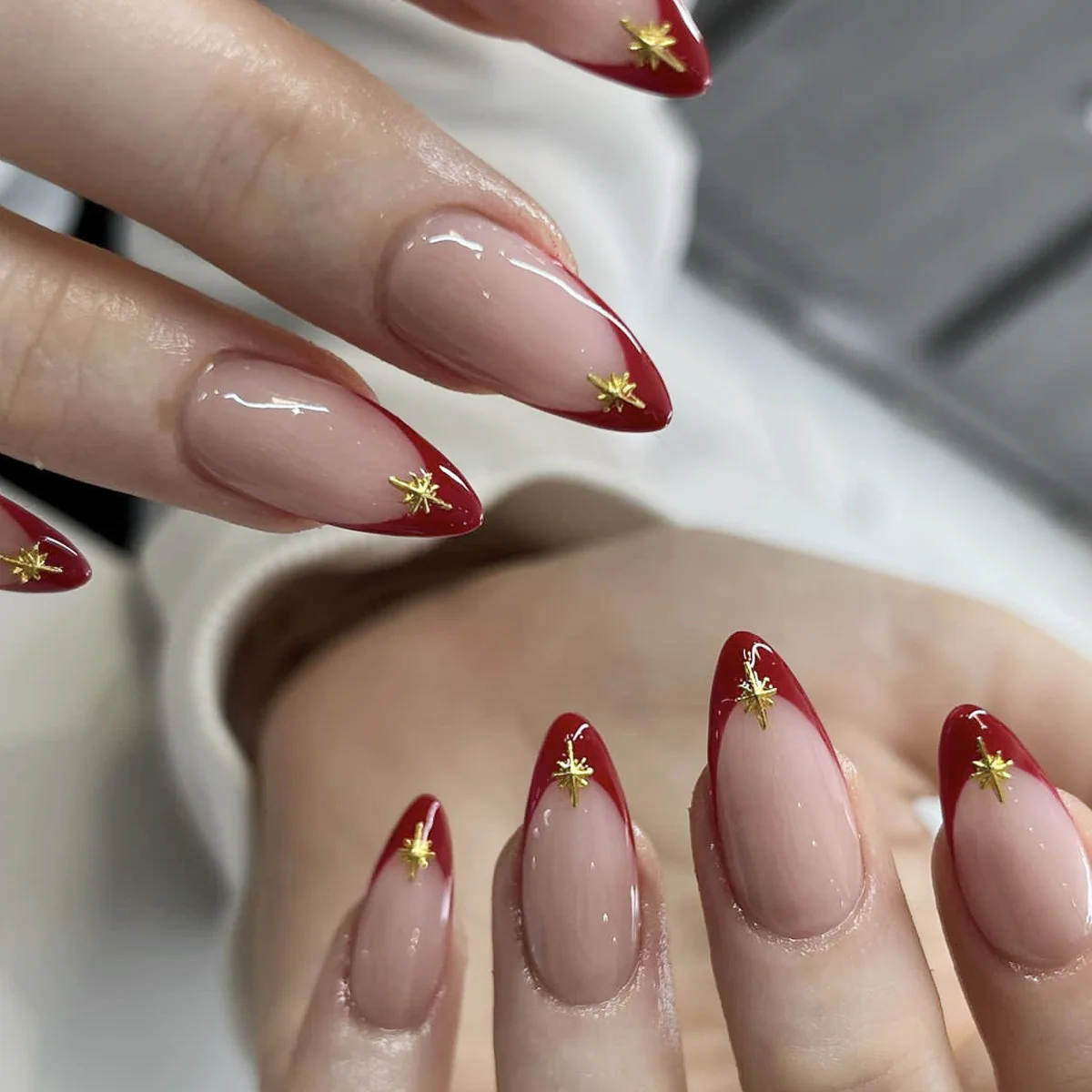 Celestial Elegance Sharp Medium Almond Beige Pink Nails with Red Tips and Gold Star Accents