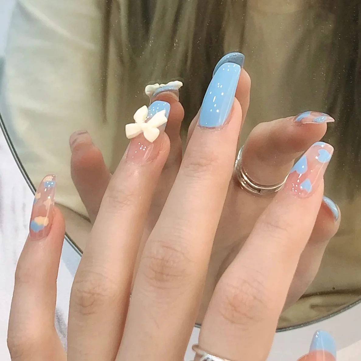 Serene Sky Medium Coffin Press on Nail Set in Sky Blue with Cloud Patterns and 3D Flower Charms