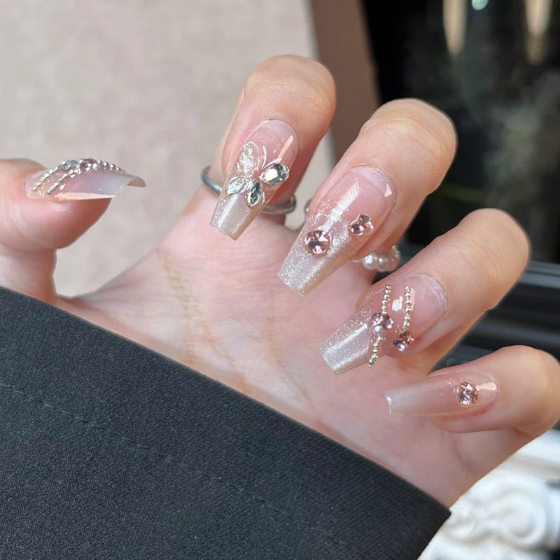Whimsical Elegance Long Coffin Champagne Nails with Sparkling Embellishments