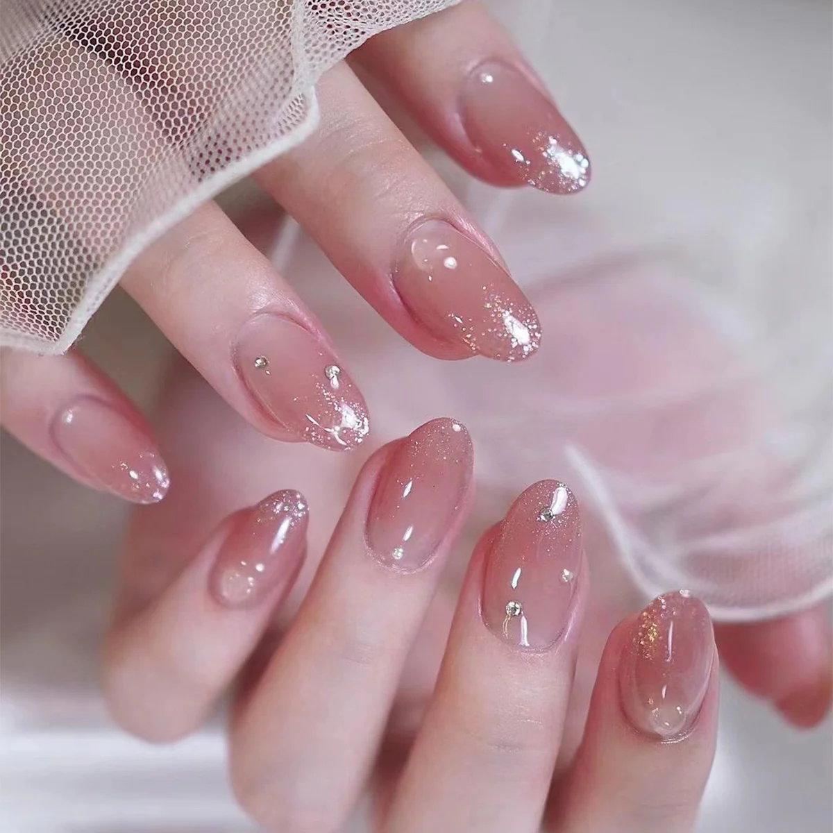 Whispering Wish Medium Oval Clear Press-On Nails with Glitter Gradient and Rhinestone Embellishments